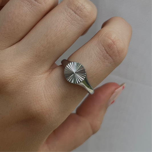 Silver sunburst signet